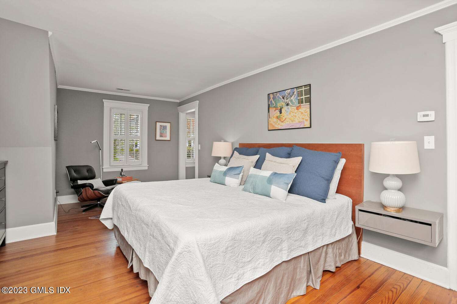 65 Ridge Street Greenwich, CT 06830 - Photo 18 of 35 a bedroom with a bed and wooden floor
