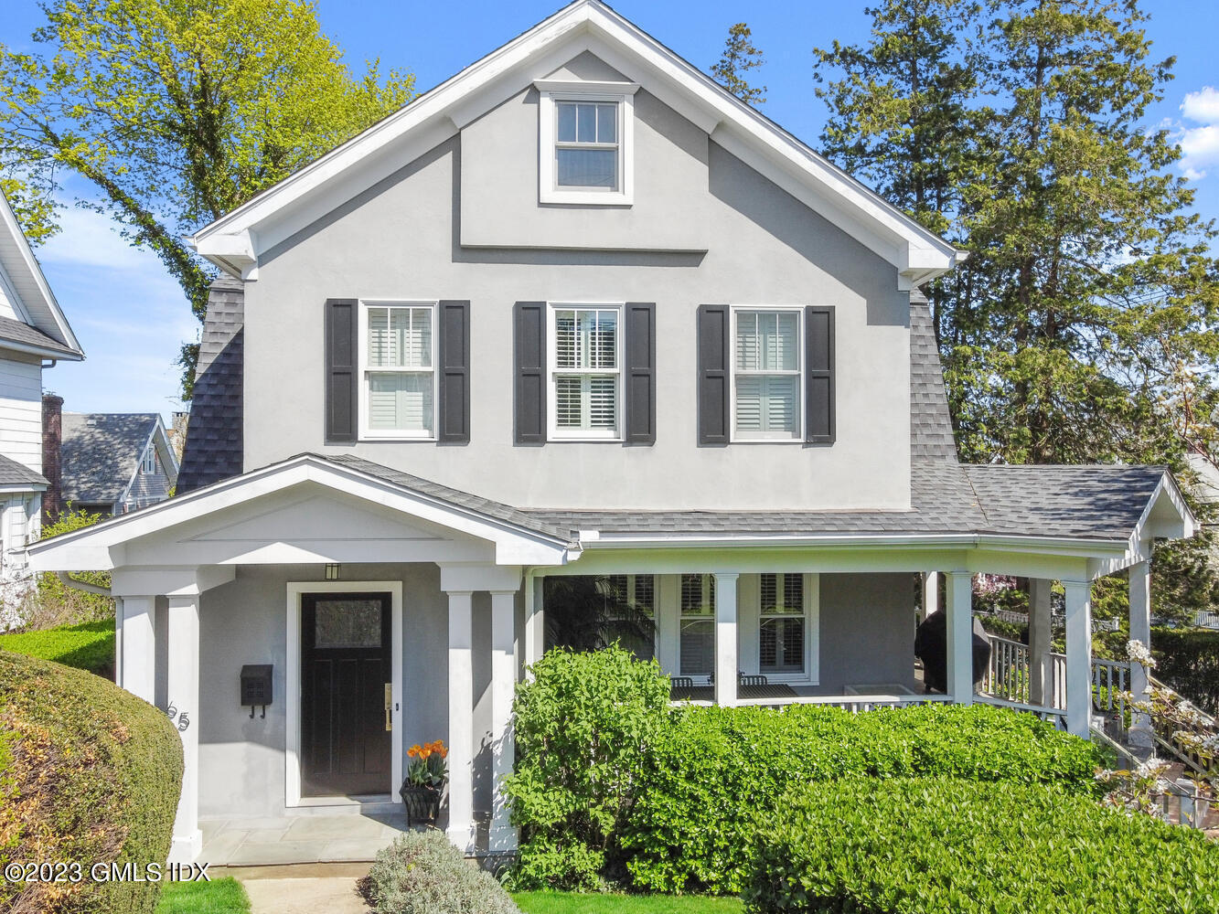 65 Ridge Street Greenwich, CT 06830 - Photo 2 of 35 a front view of a house with a yard