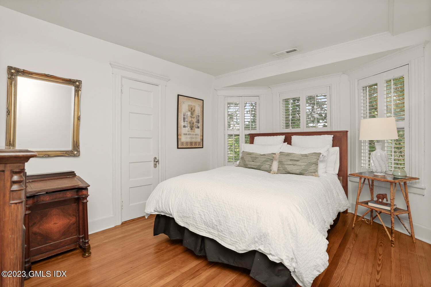 65 Ridge Street Greenwich, CT 06830 - Photo 21 of 35 a bedroom with a bed and wooden floor