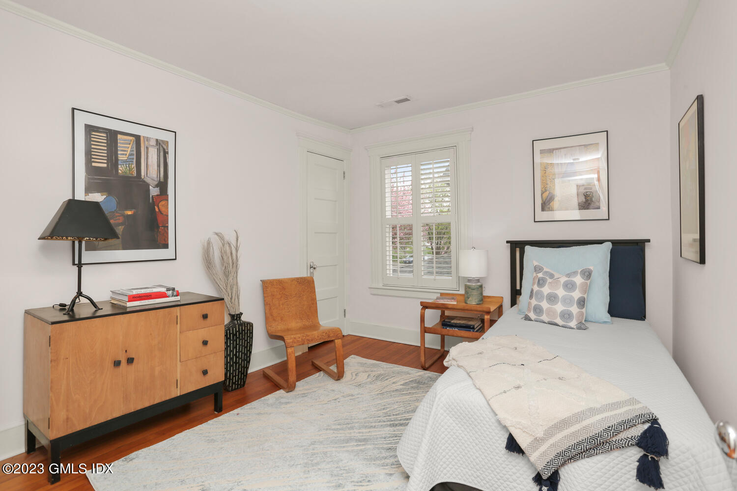 65 Ridge Street Greenwich, CT 06830 - Photo 22 of 35 a bedroom with a bed and wooden floor