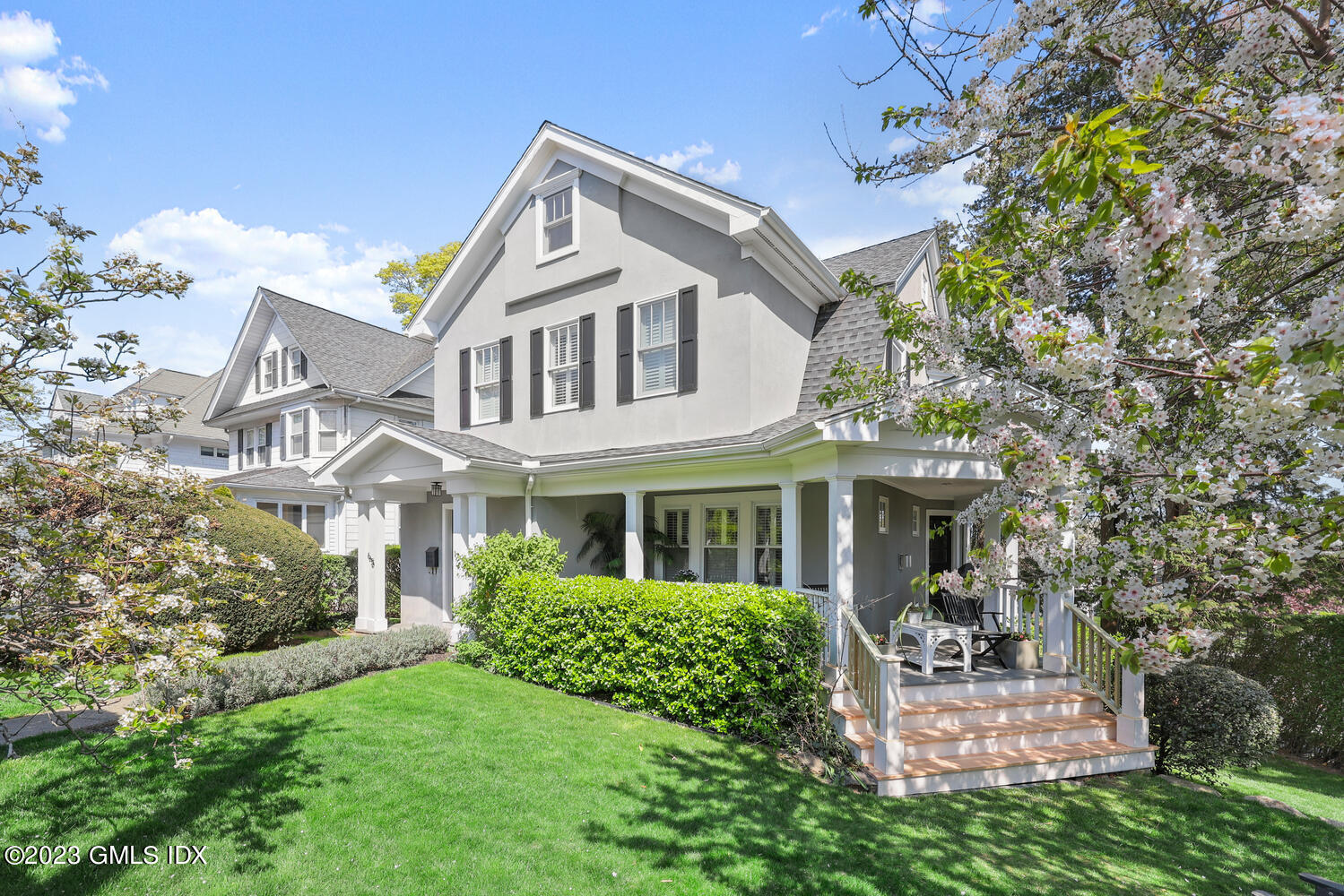 65 Ridge Street Greenwich, CT 06830 - Photo 27 of 35 a front view of a house with a garden