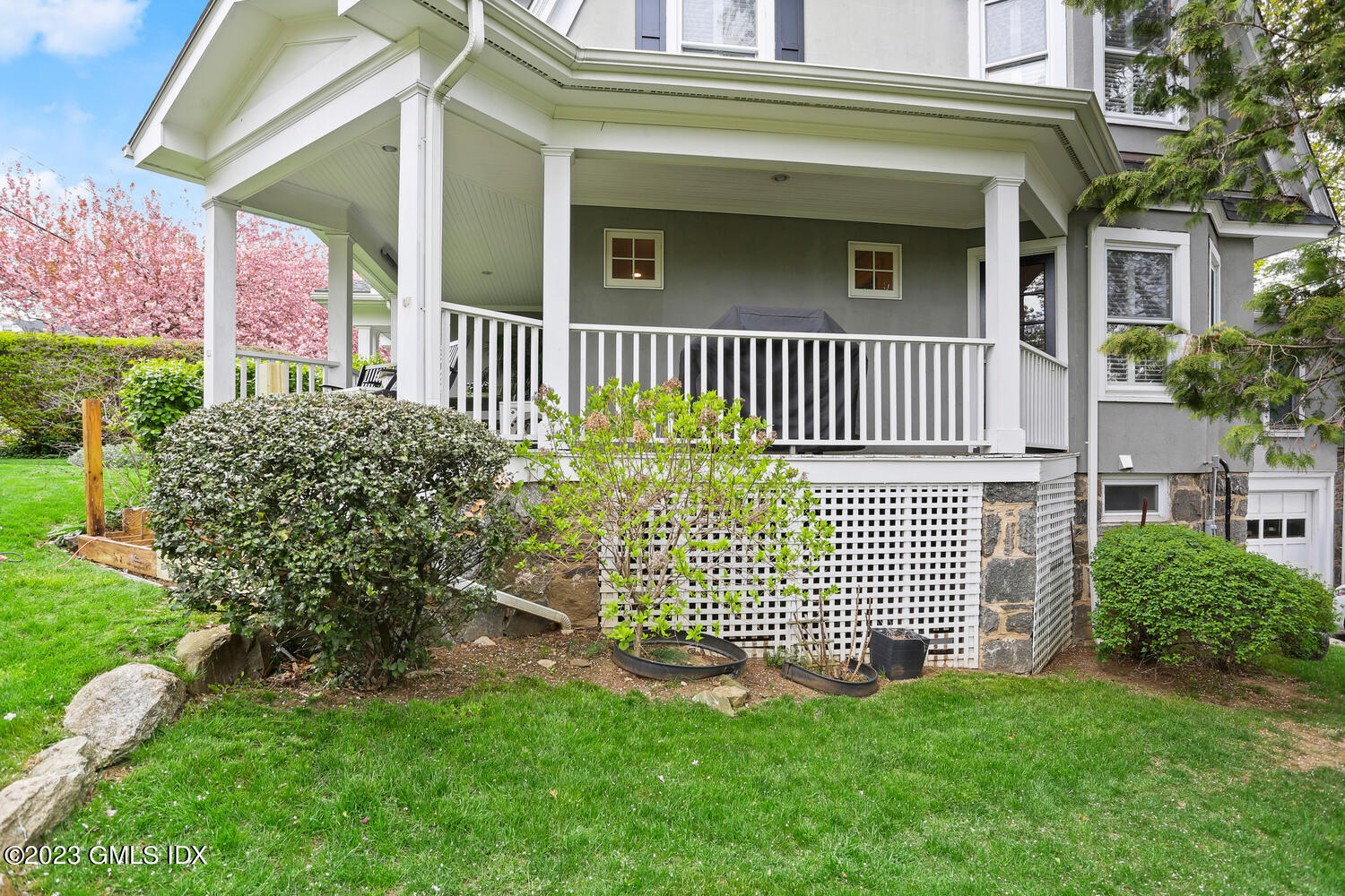 65 Ridge Street Greenwich, CT 06830 - Photo 28 of 35 a front view of a house with a garden
