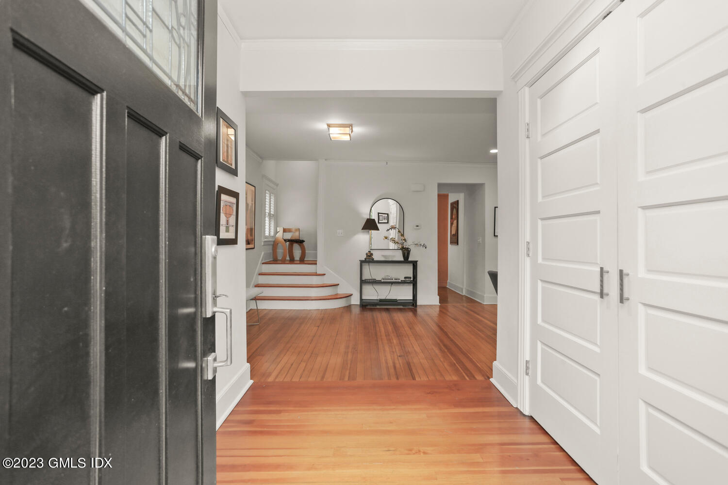 65 Ridge Street Greenwich, CT 06830 - Photo 3 of 35 a view of a hallway with wooden floor and dining room