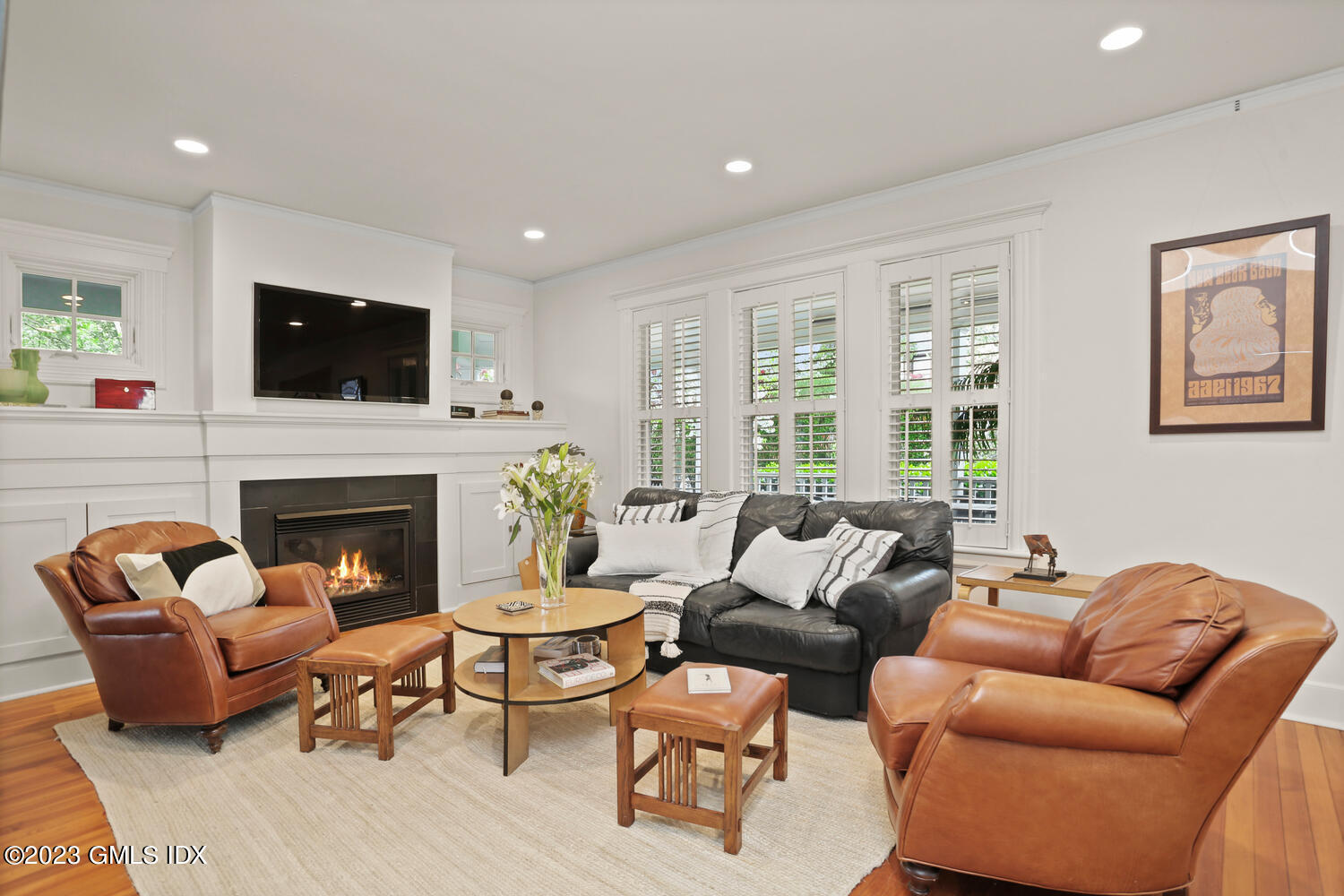 65 Ridge Street Greenwich, CT 06830 - Photo 5 of 35 a living room with furniture a flat screen tv and a fireplace