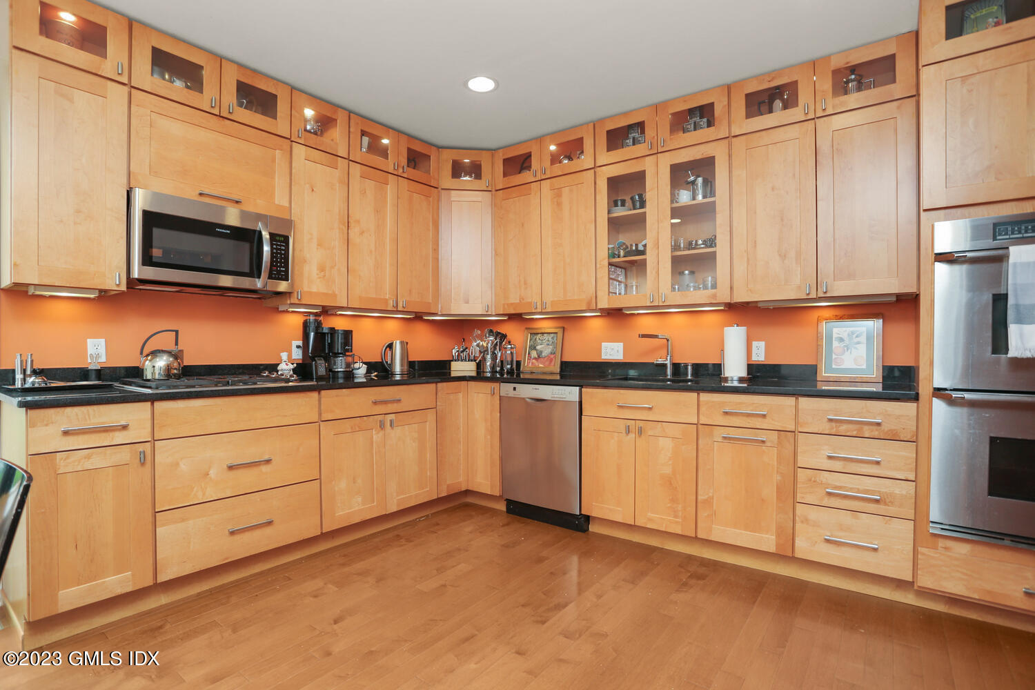 65 Ridge Street Greenwich, CT 06830 - Photo 10 of 35 a kitchen with stainless steel appliances granite countertop a stove a sink and a microwave
