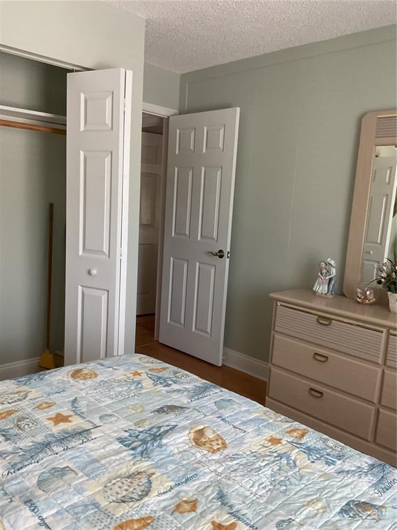 2655 Pine Ridge Way North, Unit D3 Palm Harbor, FL 34684 - Photo 20 of 31 a bed room with a bed and a mirror