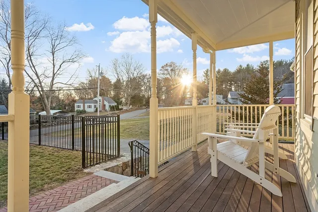 a view of a balcony with lake view and wooden floor