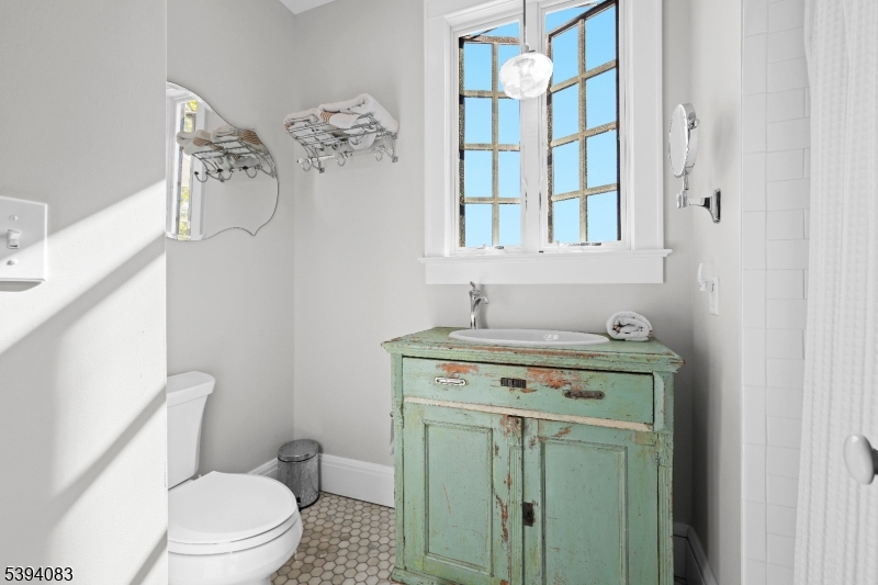 331 Lakeside Boulevard Hopatcong, NJ 07843 - Photo 17 of 34 a bathroom with a toilet sink and mirror