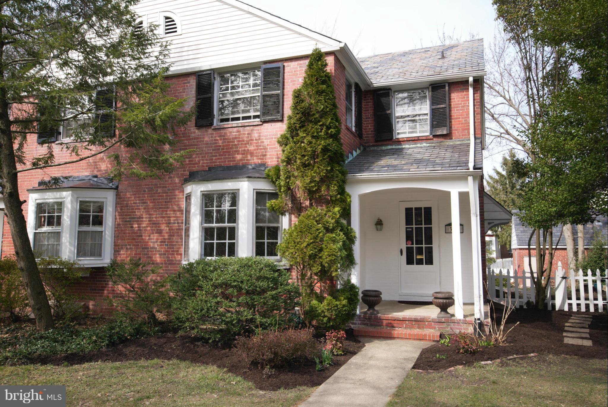 326 Paddington Road Baltimore, MD 21212 - Photo 1 of 29 a view of a white house with many windows plants and large tree
