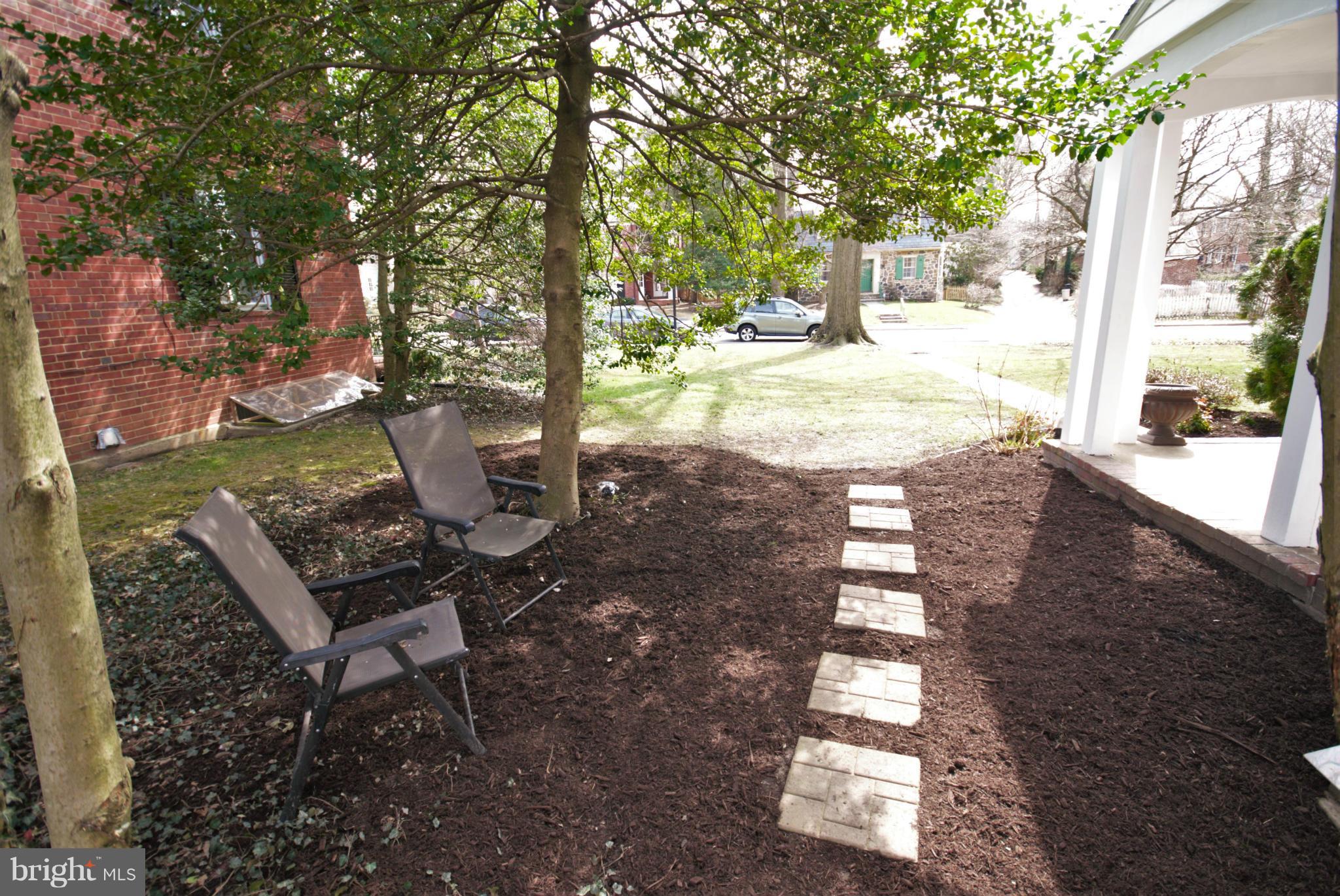 326 Paddington Road Baltimore, MD 21212 - Photo 24 of 29 a view of a patio with table and chairs with wooden fence and large trees