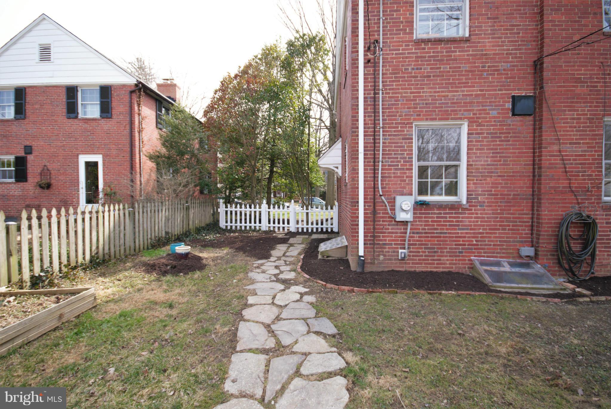 326 Paddington Road Baltimore, MD 21212 - Photo 27 of 29 a view of a brick house with many windows next to a yard