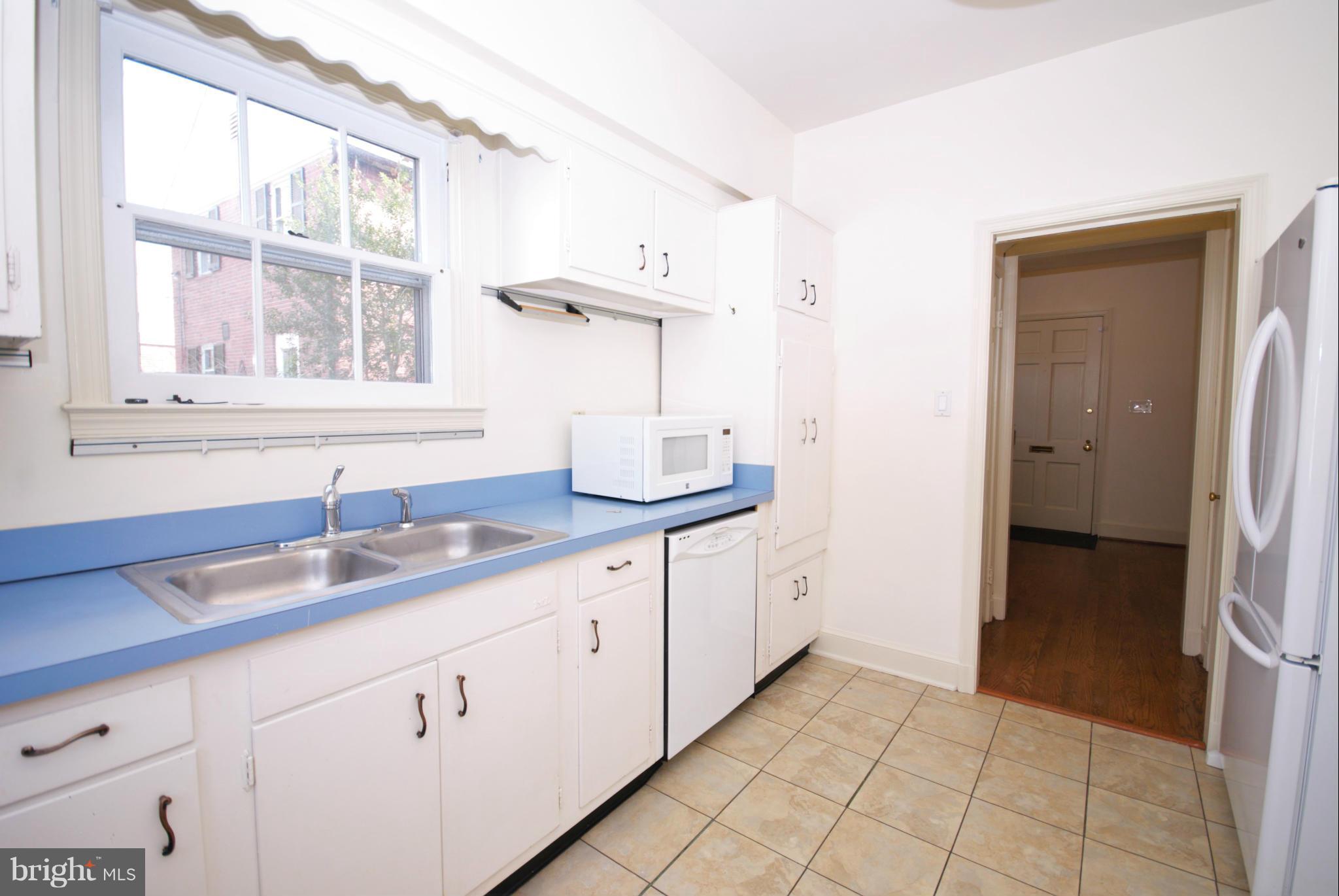 326 Paddington Road Baltimore, MD 21212 - Photo 10 of 29 a kitchen with a sink and a refrigerator