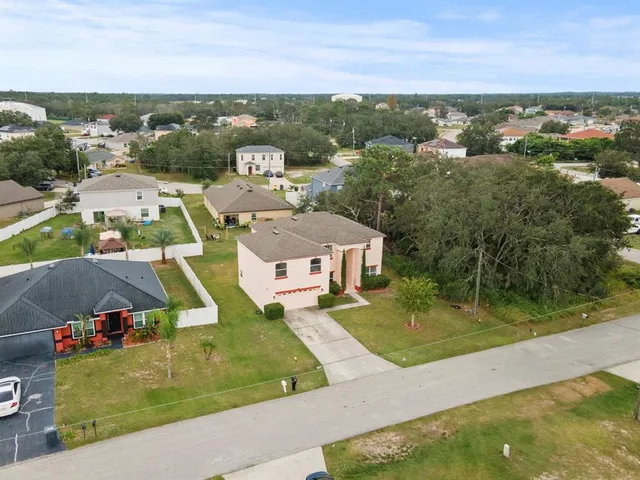 an aerial view of residential houses with outdoor space and city view