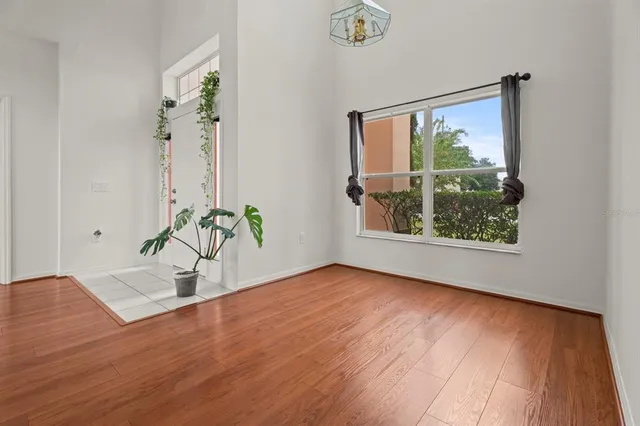 a view of a hallway with wooden floor and a couch