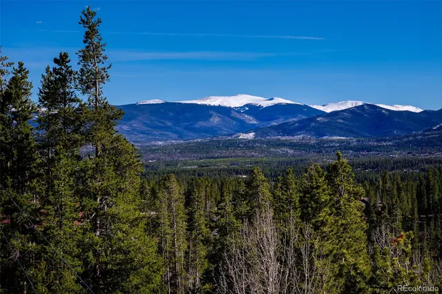 a view of a large building with a mountain in the background