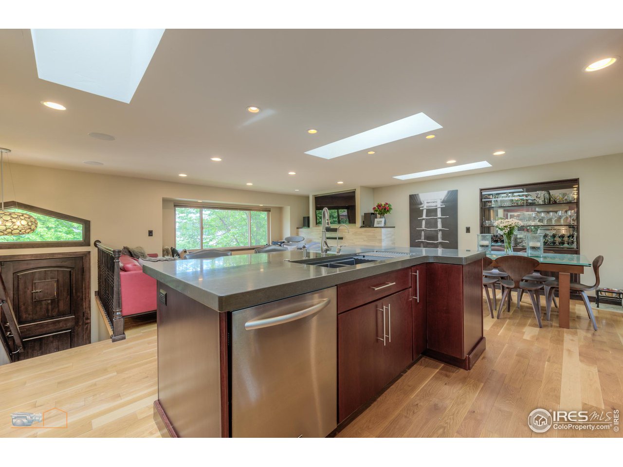 2850 Emerson Avenue Boulder, CO 80305 - Photo 12 of 40 a kitchen with stainless steel appliances granite countertop a sink dishwasher stove top oven and cabinets with wooden floor