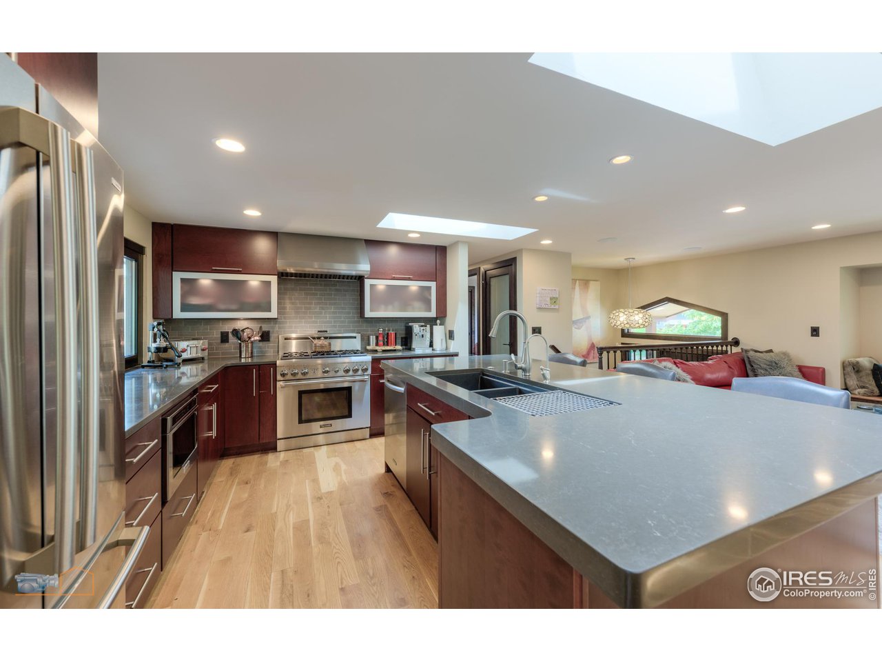 2850 Emerson Avenue Boulder, CO 80305 - Photo 13 of 40 a open kitchen with kitchen island a stove a refrigerator a sink and dishwasher with wooden floor