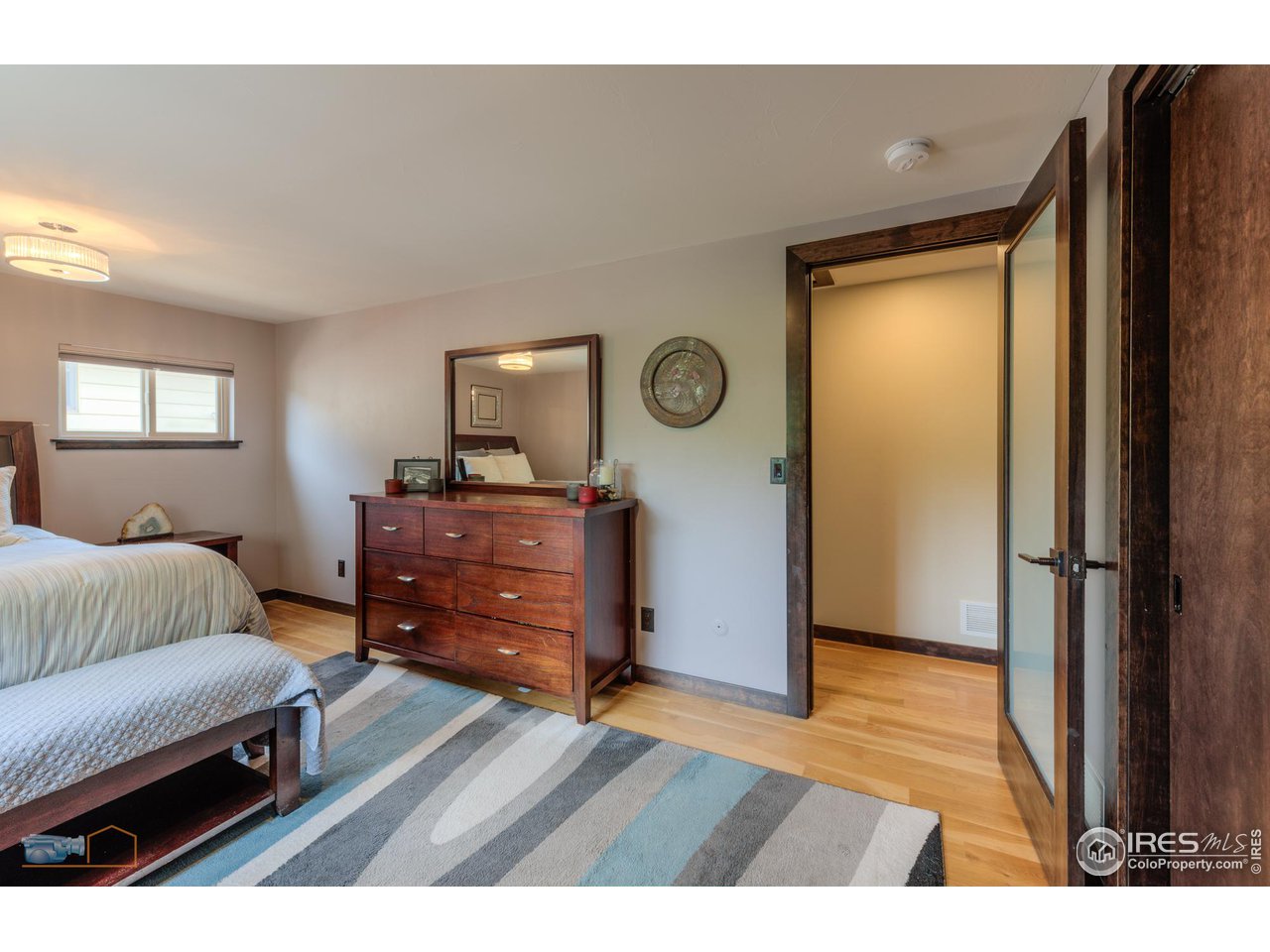 2850 Emerson Avenue Boulder, CO 80305 - Photo 18 of 40 a bedroom with a bed and a dresser in it