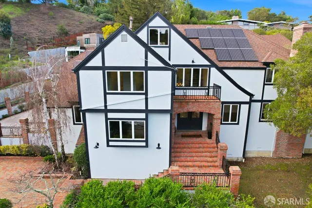 a view of empty room with wooden floor and windows