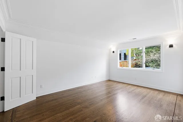 a view of wooden floor and windows in a room