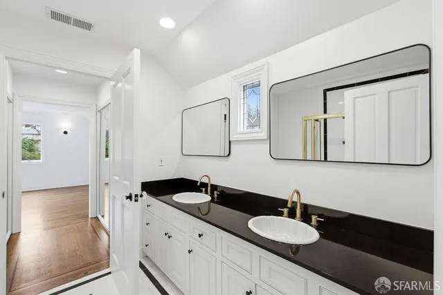 an aerial view of a house with a yard and tennis court