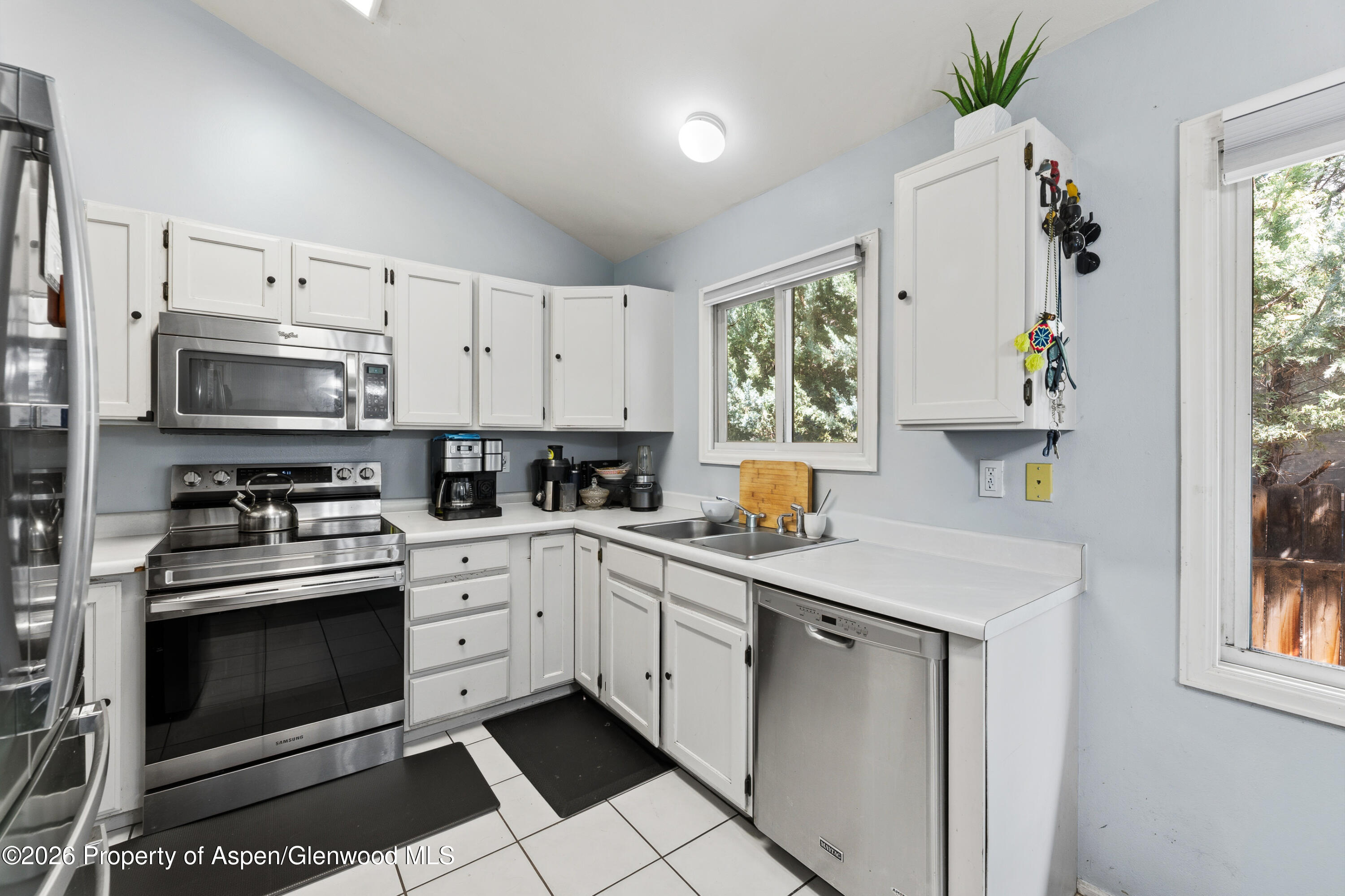 164 Current Drive New Castle, CO 81647 - Photo 13 of 34 a kitchen with white cabinets stainless steel appliances and a window