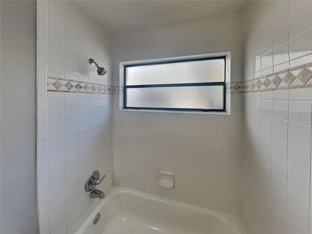a bathroom with a bathtub and shower
