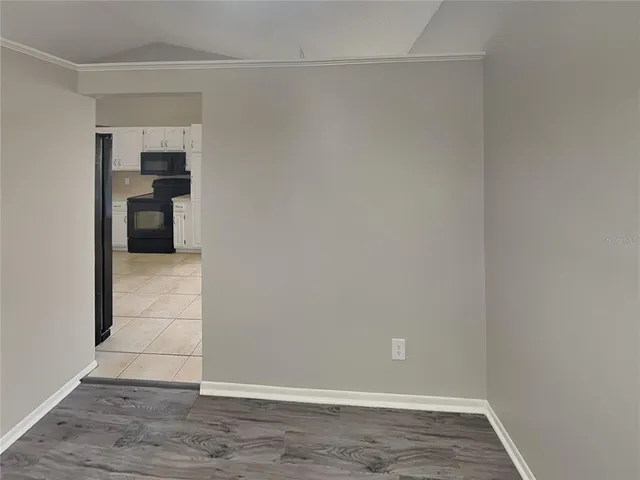 a view of a kitchen with wooden floor and a kitchen