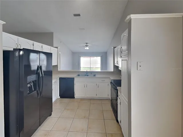 a kitchen with a refrigerator and a sink