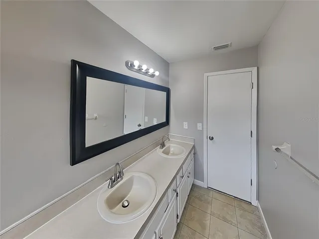 a bathroom with a sink a mirror and a toilet