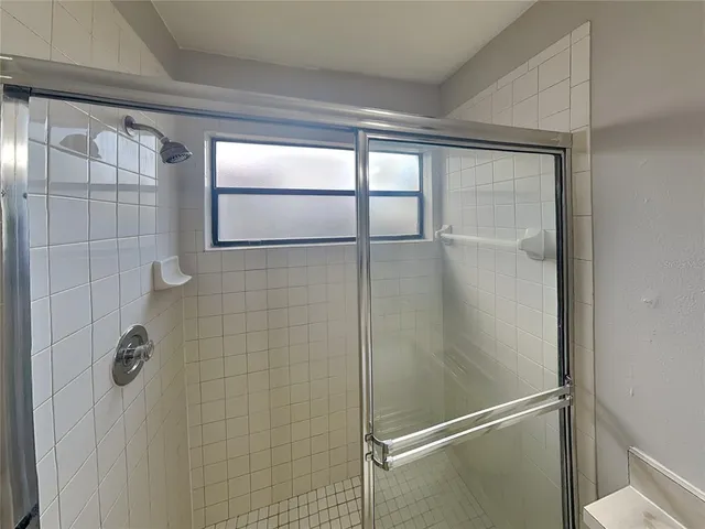 a bathroom with a glass shower door