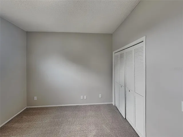 a view of an empty room and closet area