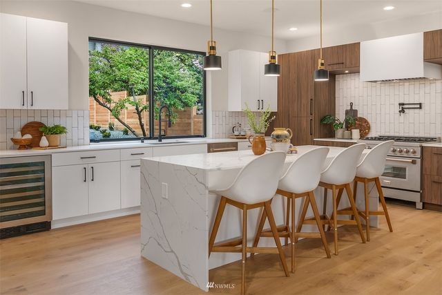 a kitchen with sink stove and cabinets