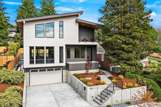 a hallway with a dining table and a large window with garden view