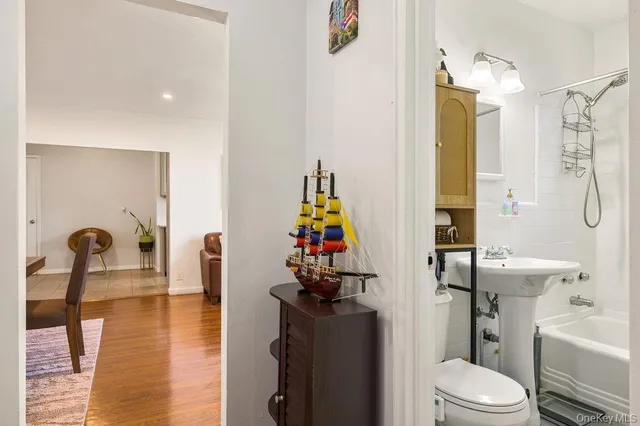a living room with furniture a rug and a dining table
