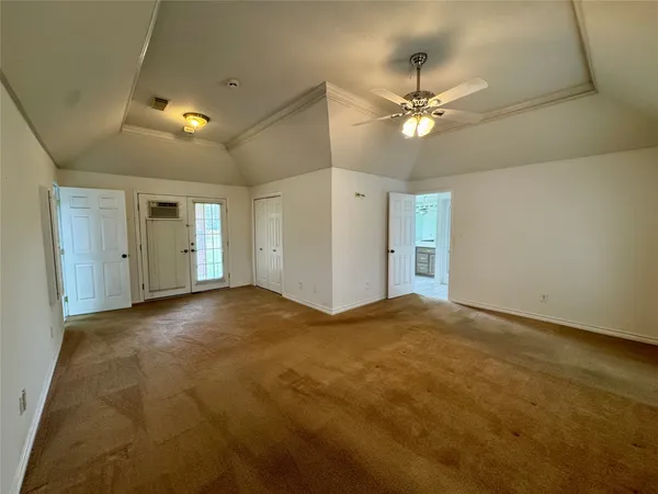 a view of an empty room with a ceiling fan