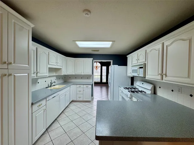 a kitchen with stainless steel appliances granite countertop a refrigerator sink and cabinets