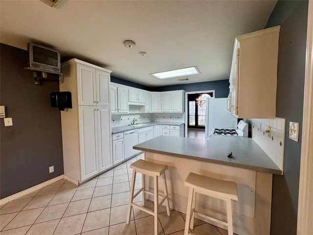 a kitchen with stainless steel appliances a sink and a refrigerator