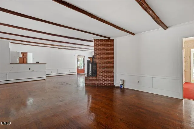 a kitchen with white cabinets and refrigerator