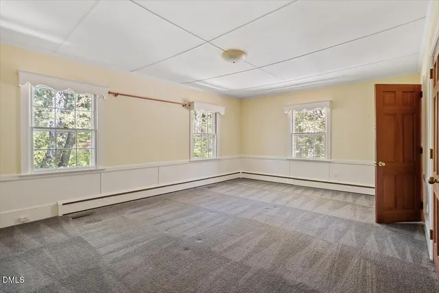 a bathroom with a granite countertop sink and a large mirror