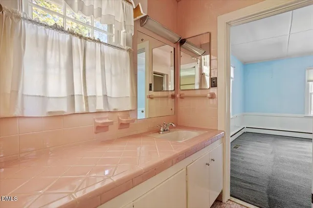 a view of a livingroom with furniture a fireplace and window