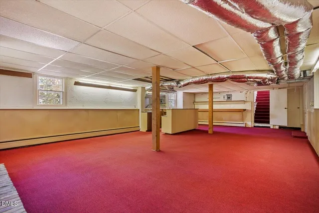 a view of a house with a yard covered with snow