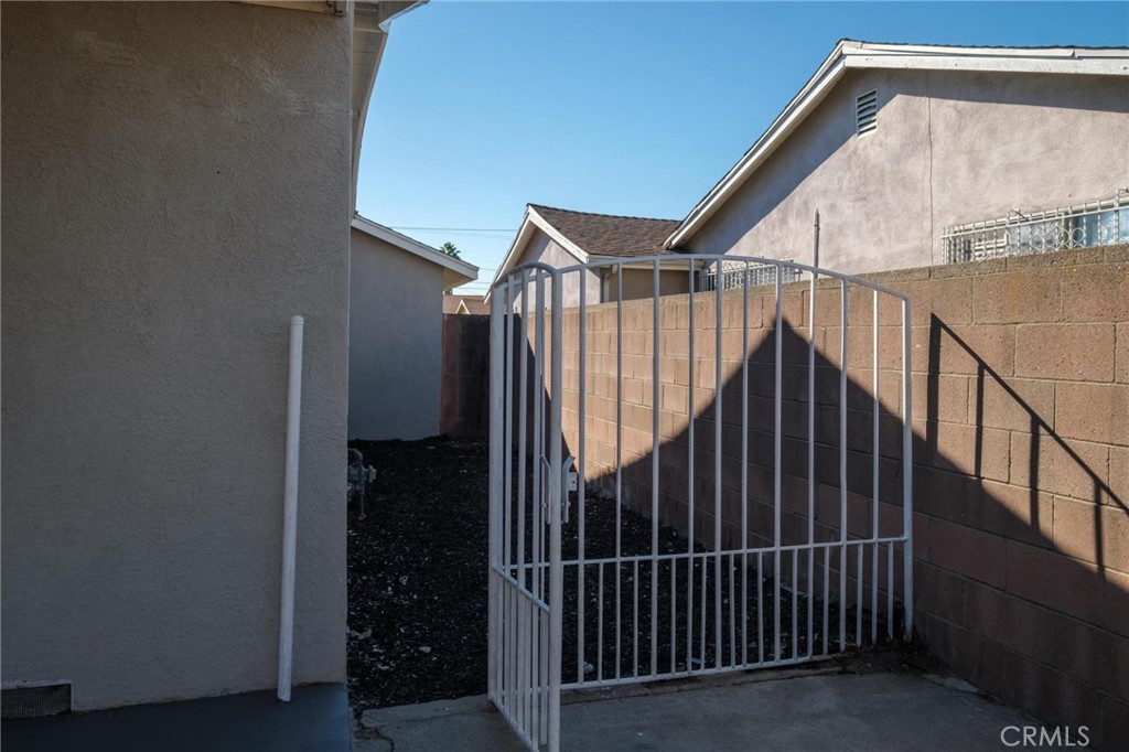 1613 West Piru Street Compton, CA 90222 - Photo 13 of 40 a view of staircase with railing and white walls
