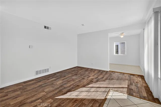 a view of a room with wooden floor and window