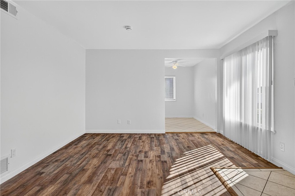 1613 West Piru Street Compton, CA 90222 - Photo 17 of 40 a view of a room with wooden floor and window