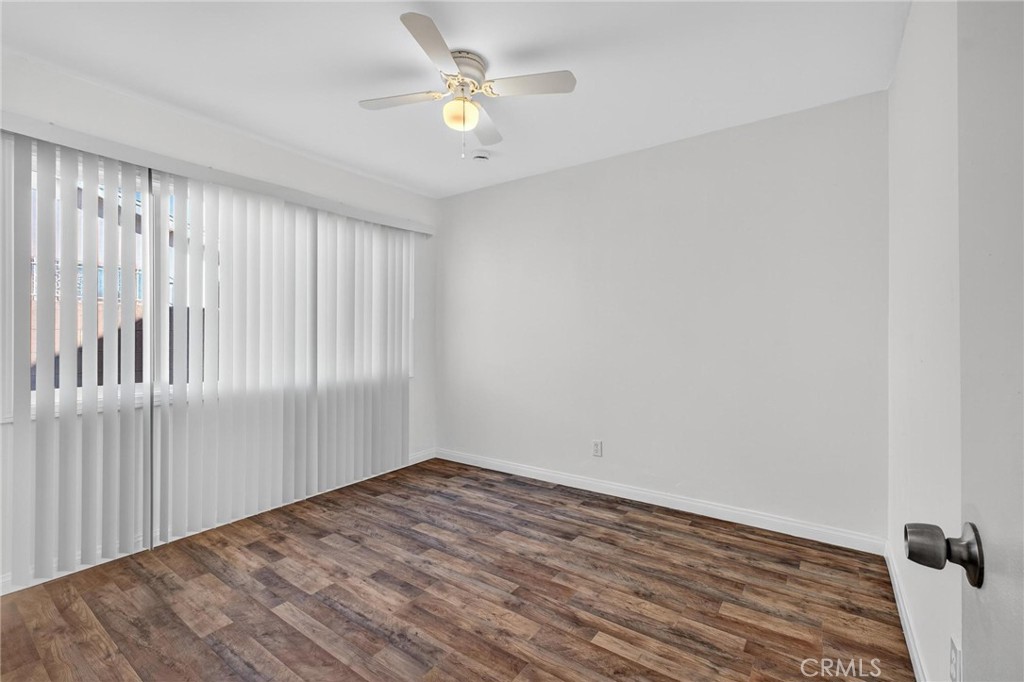 1613 West Piru Street Compton, CA 90222 - Photo 21 of 40 wooden floor in an empty room with a window