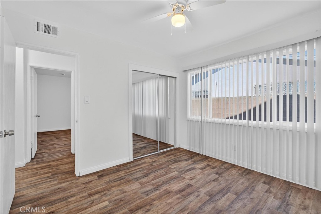 1613 West Piru Street Compton, CA 90222 - Photo 22 of 40 a view of an empty room with wooden floor