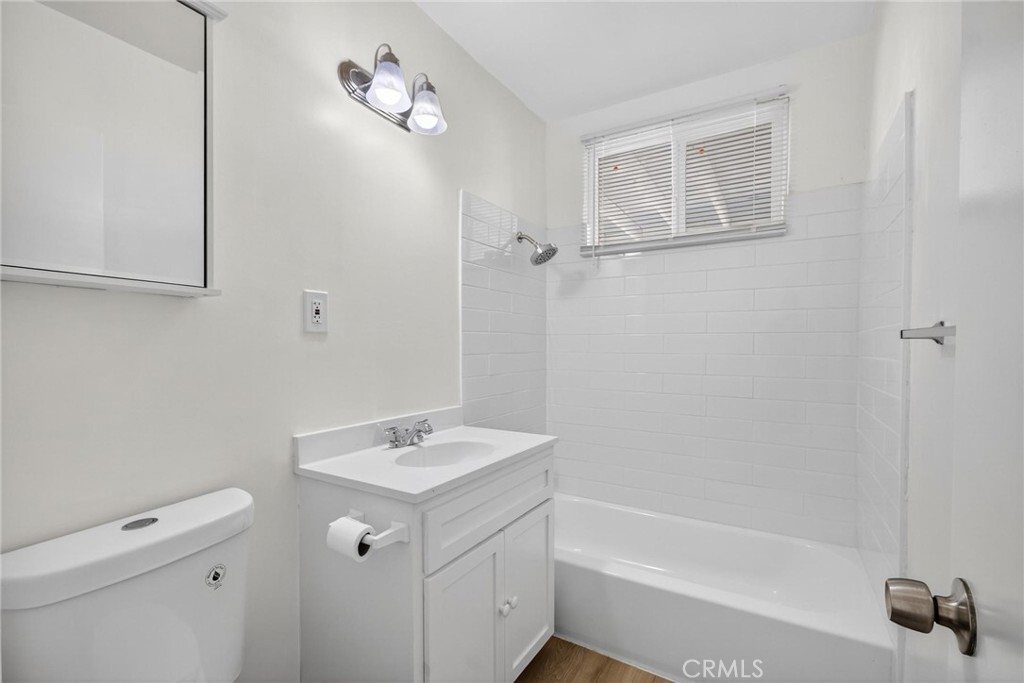 1613 West Piru Street Compton, CA 90222 - Photo 25 of 40 a bathroom with a sink a toilet and shower