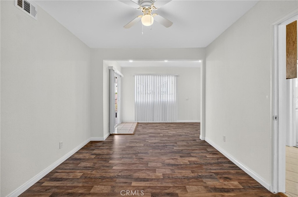 1613 West Piru Street Compton, CA 90222 - Photo 27 of 40 a view of an empty room with wooden floor and a window