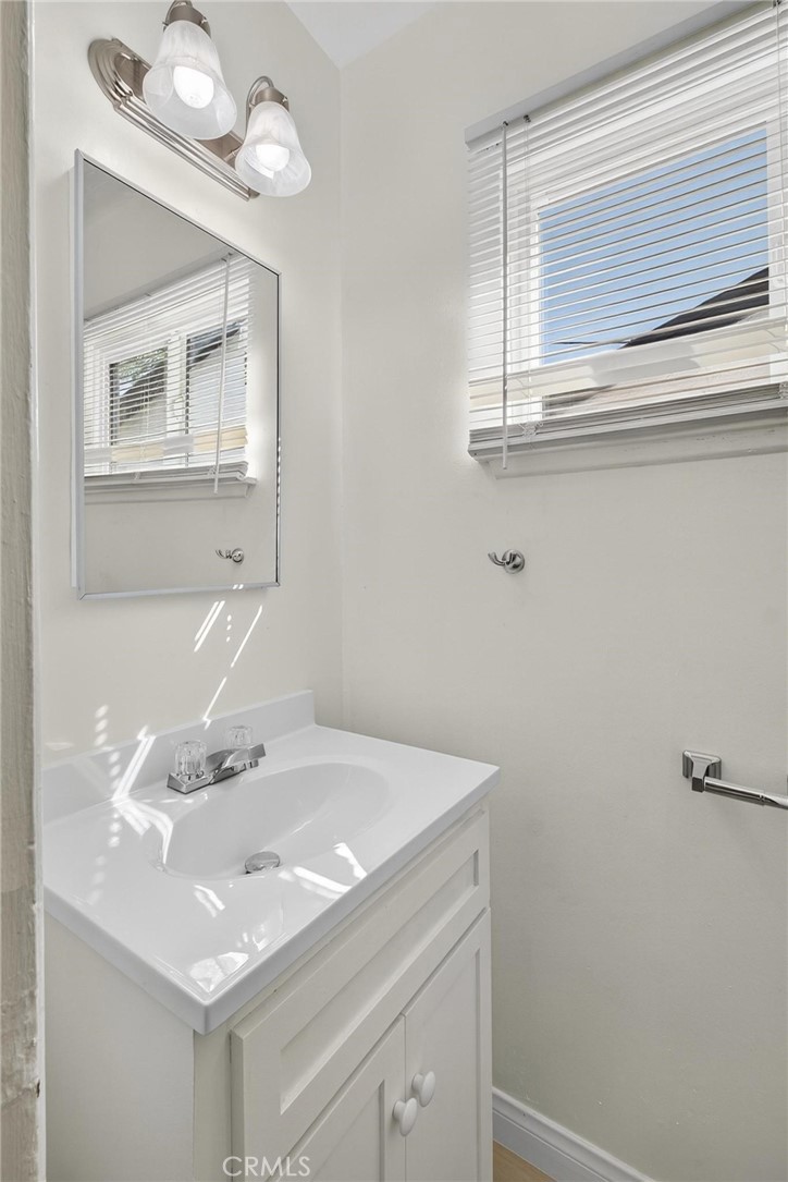 1613 West Piru Street Compton, CA 90222 - Photo 33 of 40 a bathroom with a sink and a mirror